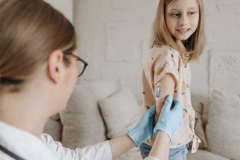 Juvenile Diabetes - Child testing blood with doctor